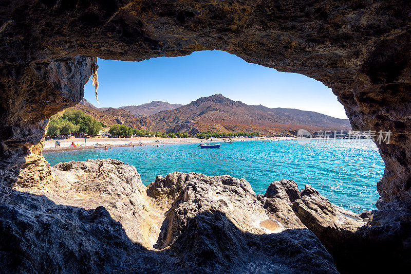 希腊克里特岛的Panagia Tripiti迷人的热带海滩，有沙滩，碧绿的水和一些幸运的露营者。